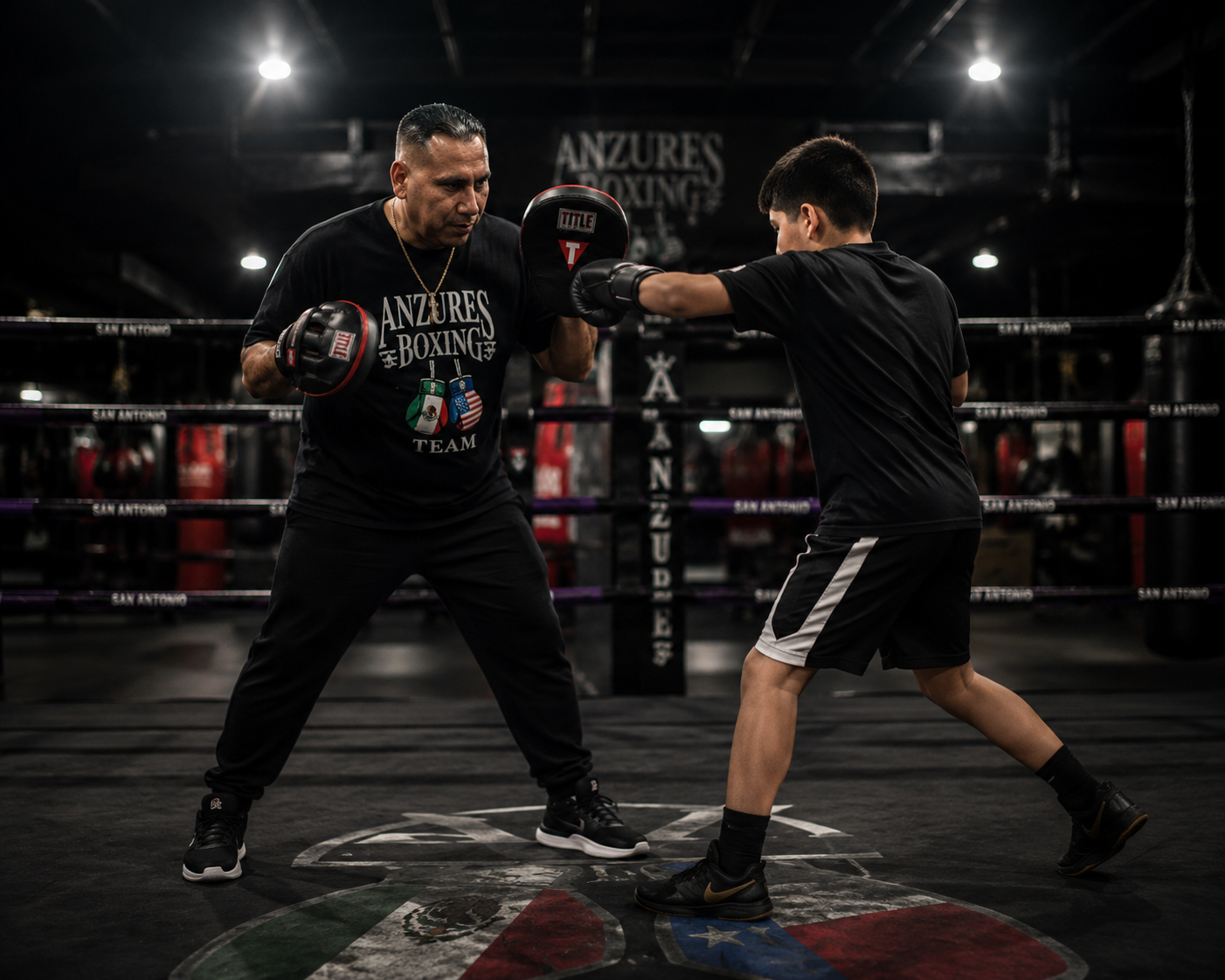 Coach training young boxer at Anzures Boxing Team, San Antonio